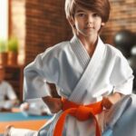 Young student wearing orange belt in karate practicing a kata